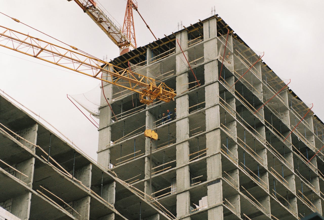 A towering construction site featuring a crane and concrete structure during its development phase.